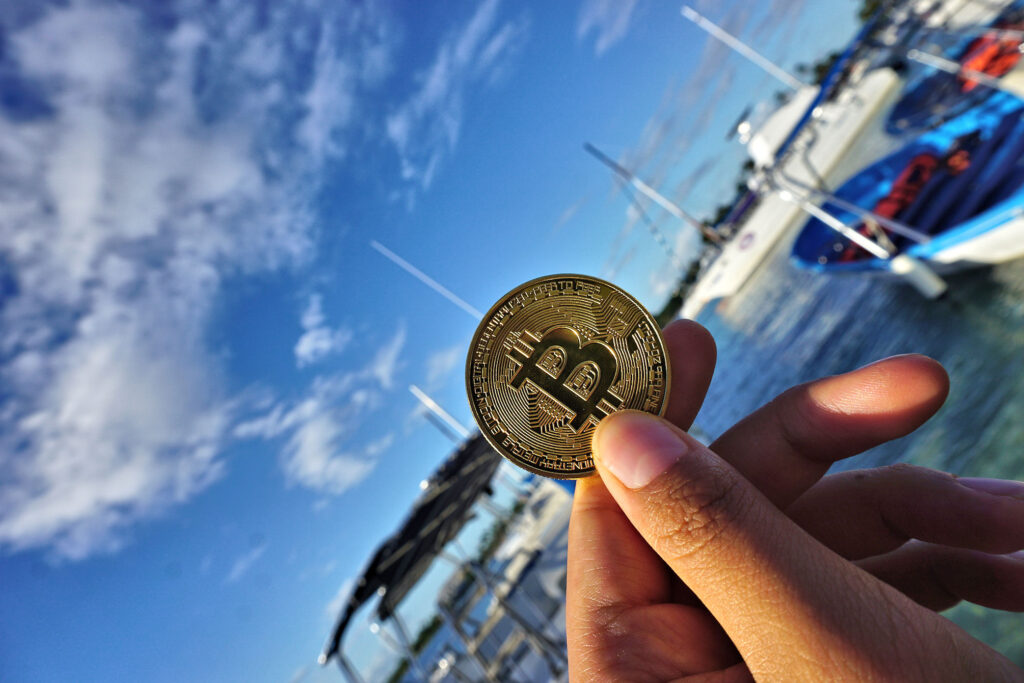 Bitcoin Token ($BTC) In Front of Ocean Yachts And Boats on Caribbean Ocean Ⓒ 2023 – Crypto Coin Opps