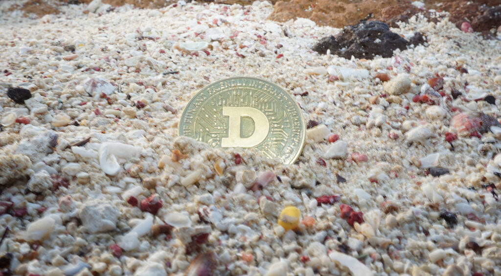 Dogecoin in beach gravel Ⓒ 2023 – Crypto Coin Opps
