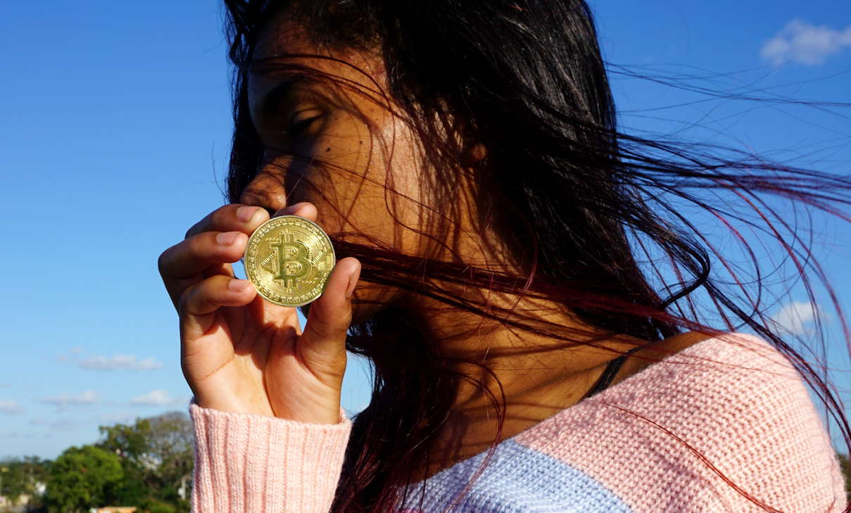 Young Latina Woman Holds Bitcoin Crypto-Coin